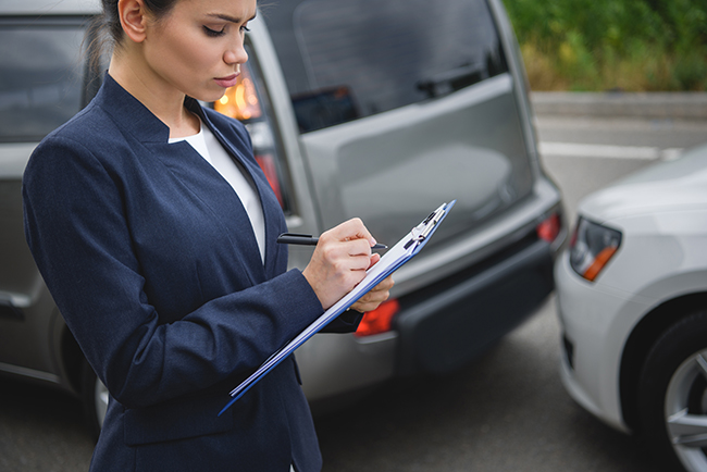 Home side view of attractive woman writing something to car insurance